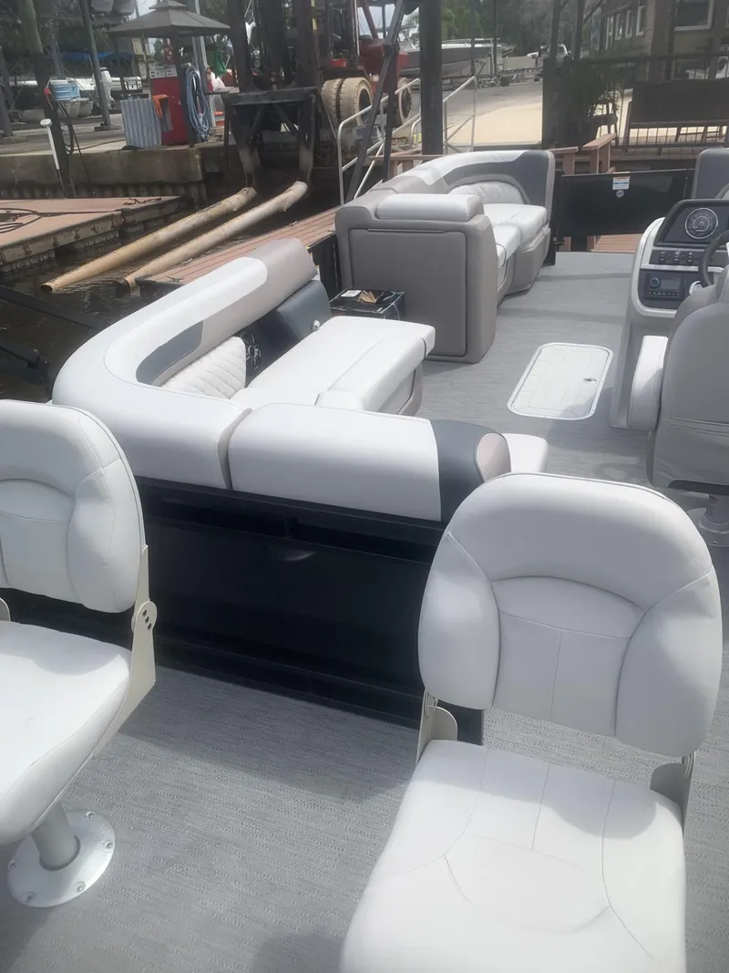 Slide: The Image of 2026 Godfrey Sweetwater 2286 FS pontoon boat with white seating and spacious deck layout. - 4