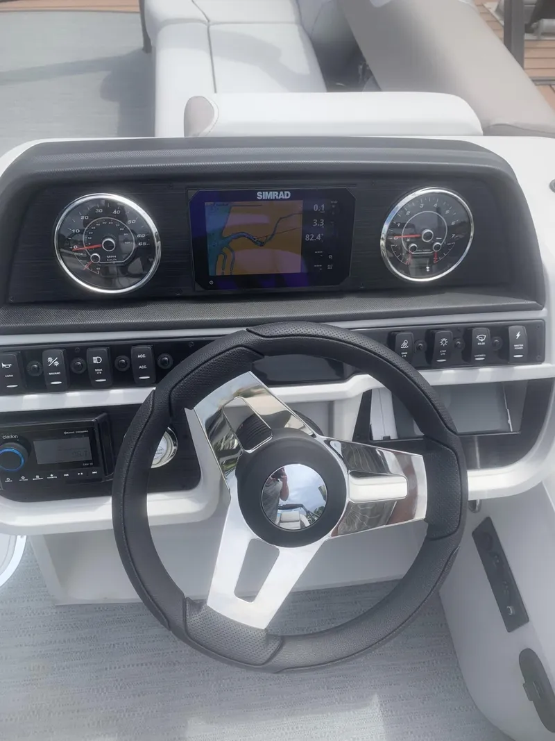 Slide: The Image of Steering console of 2026 Godfrey Sweetwater 2286 FS with modern controls and navigation display. - 7