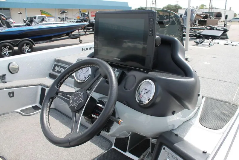 Slide: The Image of 2020 Phoenix 921 ELITE boat dashboard with steering wheel and Garmin display. - 4