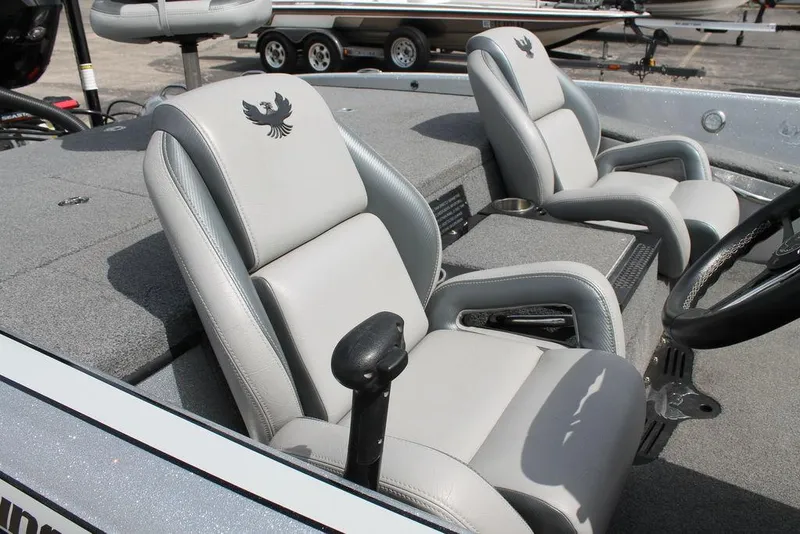 Slide: The Image of 2020 Phoenix 921 ELITE boat interior with gray seats and steering wheel. - 6