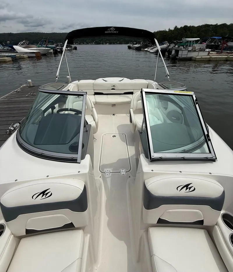 Slide: The Image of 2012 Monterey 204FS boat docked at a marina, featuring open seating and windshield. - 3