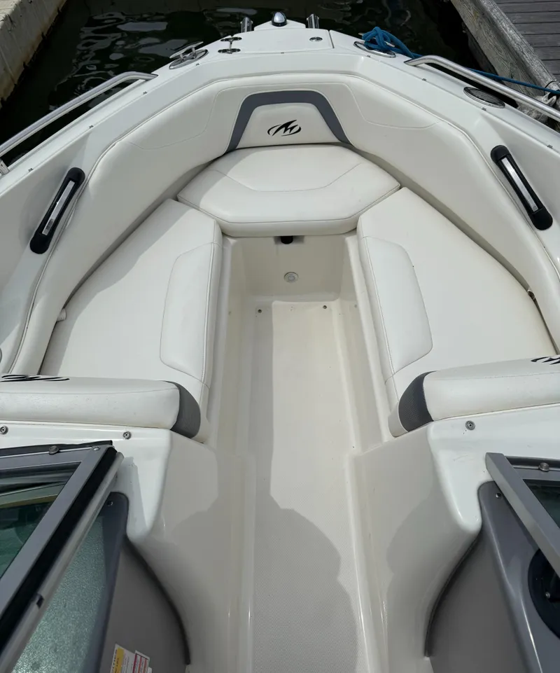 Slide: The Image of 2012 Monterey 204FS boat interior with white seating and logo. - 4