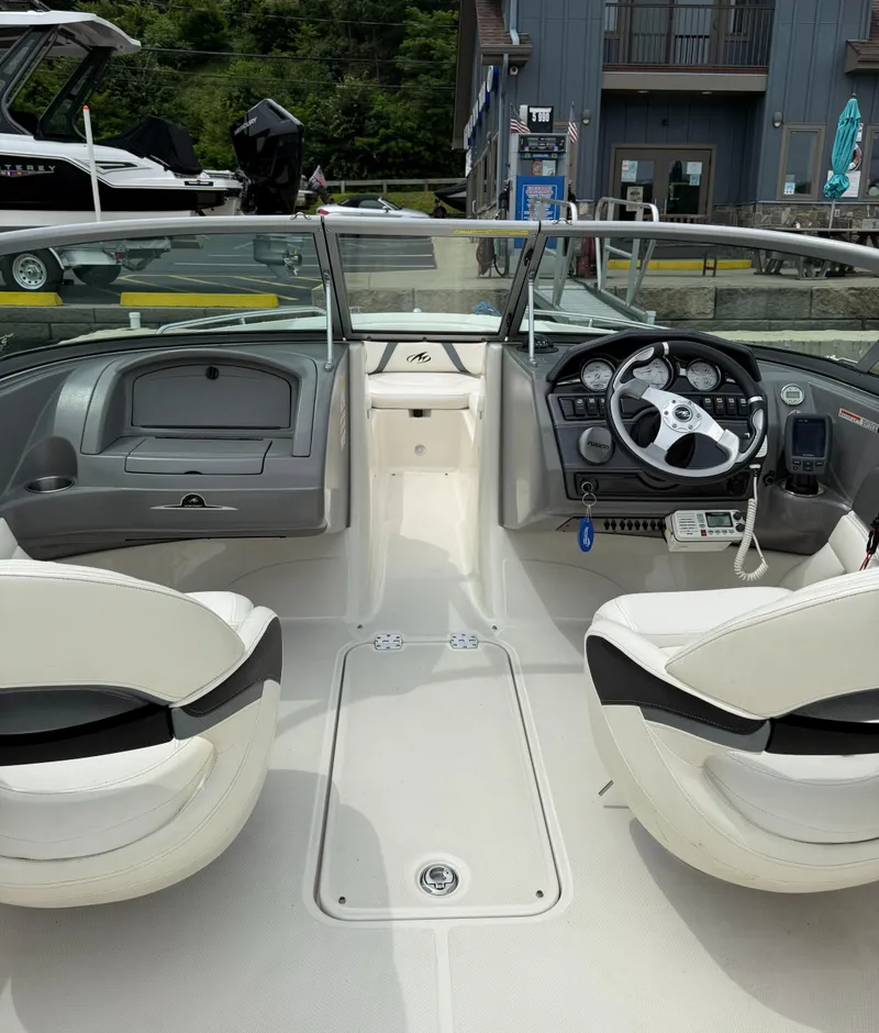 Slide: The Image of Interior view of a 2012 Monterey 204FS boat, featuring steering wheel and seating. - 6