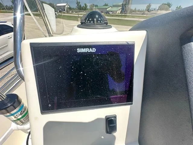 Slide: The Image of Simrad display on 2007 Boston Whaler 200 Dauntless boat dashboard with compass. - 11