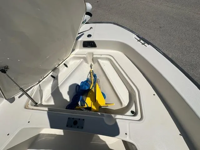 Slide: The Image of Open storage compartment on 2007 Boston Whaler 200 Dauntless boat with anchor inside. - 15