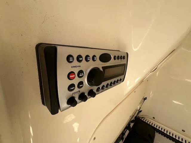 Slide: The Image of Control panel on a 2007 Boston Whaler 200 Dauntless boat, featuring various buttons and a display. - 18