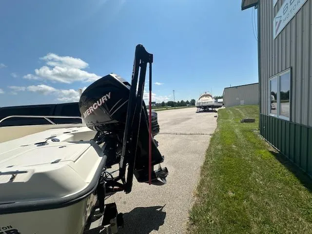 Slide: The Image of 2007 Boston Whaler 200 Dauntless with Mercury engine, parked outdoors near a storage facility. - 5