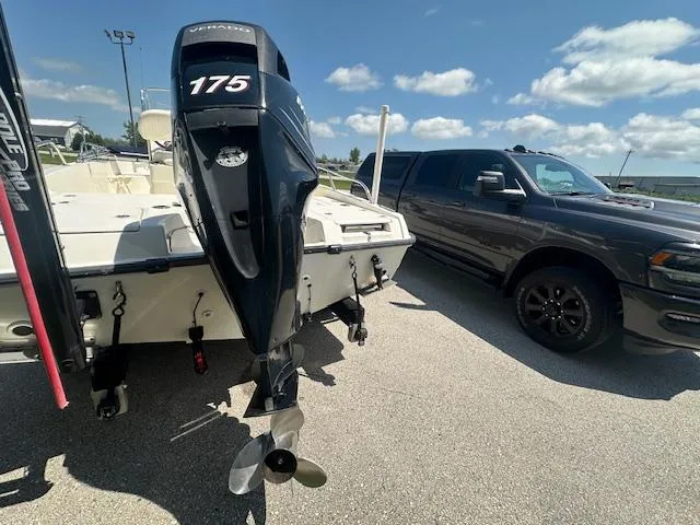 Slide: The Image of 2007 Boston Whaler 200 Dauntless boat with 175 HP engine, parked beside a black truck. - 6