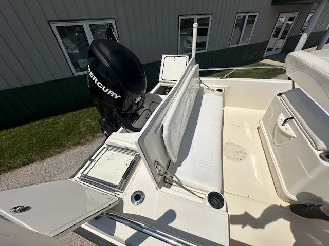 Slide: The Image of 2007 Boston Whaler 200 Dauntless boat with Mercury engine, featuring seating and storage compartments. - 9