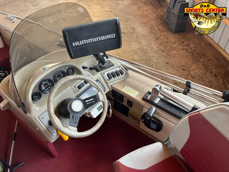 Slide: The Image of 1997 Lund 1900 Pro-V LE boat dashboard with Humminbird fish finder and steering wheel. - 8