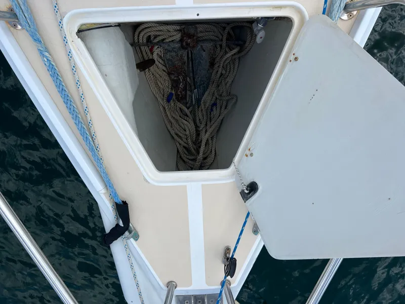 Slide: The Image of Open anchor locker on 2001 J Boats J/120 sailboat, showing coiled ropes and anchor. - 10