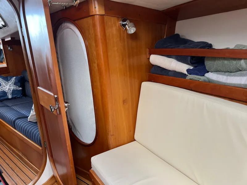 Slide: The Image of Interior of 2001 J Boats J/120 sailboat with wooden finish and cozy seating. - 21