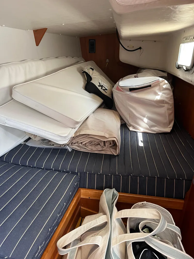 Slide: The Image of Interior cabin of 2001 J Boats J/120 with cushions and bags. - 23