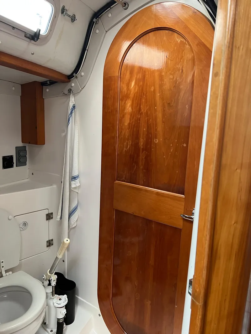 Slide: The Image of Interior of 2001 J Boats J/120 yacht bathroom with wooden door and toilet. - 30
