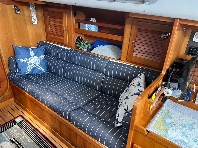 Slide: The Image of Cozy interior of 2001 J Boats J/120 with striped cushions and nautical decor. - 32