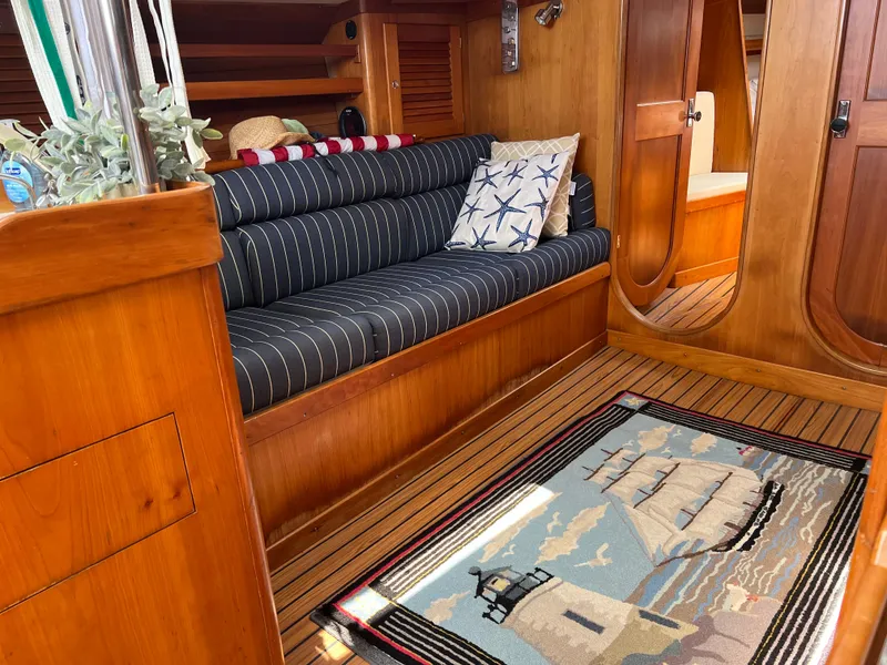 Slide: The Image of Cozy interior of 2001 J Boats J/120 with nautical decor and striped seating. - 37