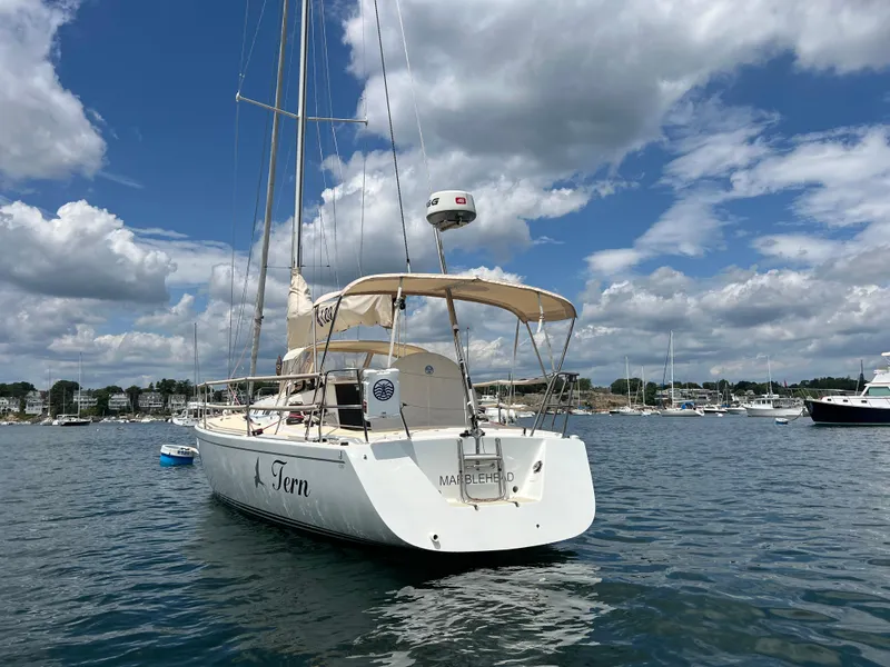 Slide: The Image of 2001 J Boats J/120 sailboat on water under a partly cloudy sky. - 5