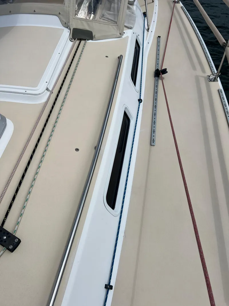 Slide: The Image of 2001 J Boats J/120 deck with ropes and fittings, showcasing sleek design. - 6