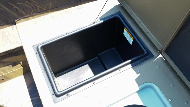 Slide: The Image of Storage compartment in 2025 G3 Gator Tough 20 CC boat, open and empty. - 12