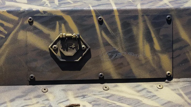 Slide: The Image of 2025 G3 Gator Tough 20 CC boat with camouflage pattern and metal latch detail. - 14