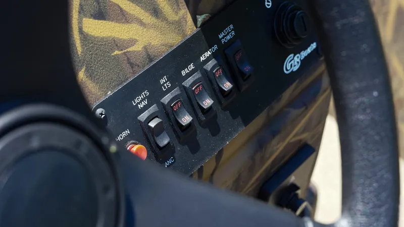 Slide: The Image of Control panel of 2025 G3 Gator Tough 20 CC boat with switches and steering wheel. - 17