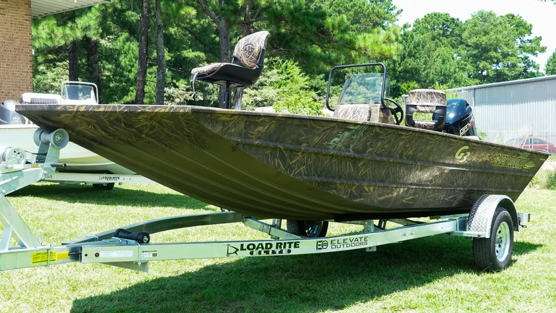 Slide: The Image of 2025 G3 Gator Tough 20 CC boat on trailer, camo design, parked on grass. - 2