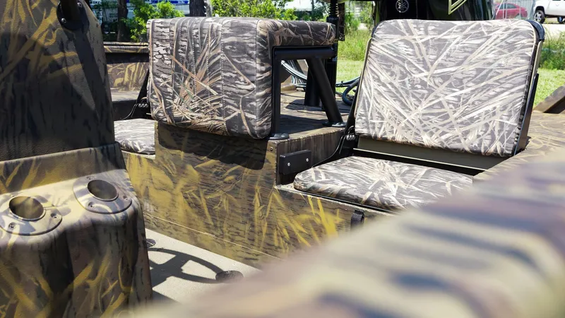 Slide: The Image of 2025 G3 Gator Tough 20 CC boat with camouflage seating and cup holders. - 3