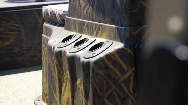 Slide: The Image of 2025 G3 Gator Tough 20 CC boat console with camouflage design and cup holders. - 4