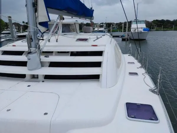 Slide: The Image of Sailing catamaran Leopard 46, 2011 model, docked at marina with overcast sky. - 27