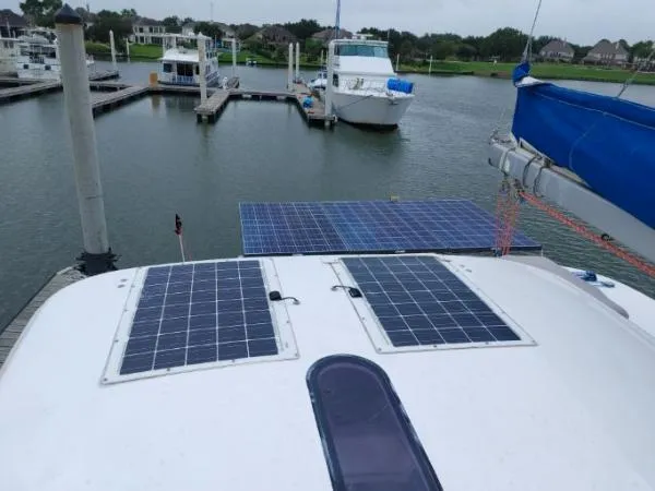 Slide: The Image of Sailboat with solar panels docked at marina, Leopard 46 model, 2011. - 28
