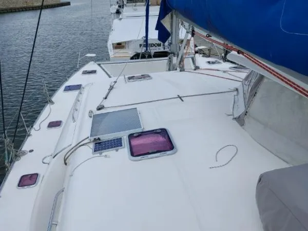 Slide: The Image of 2011 Leopard 46 catamaran deck with hatches, docked in a marina. - 30