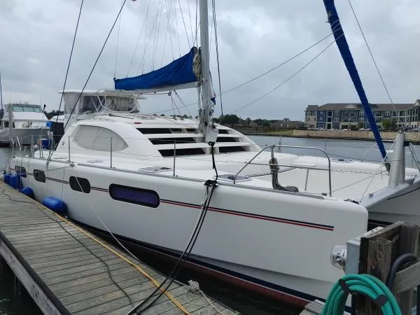 Slide: The Image of Sailing catamaran Leopard 46, 2011 model, docked at marina with overcast sky. - 31