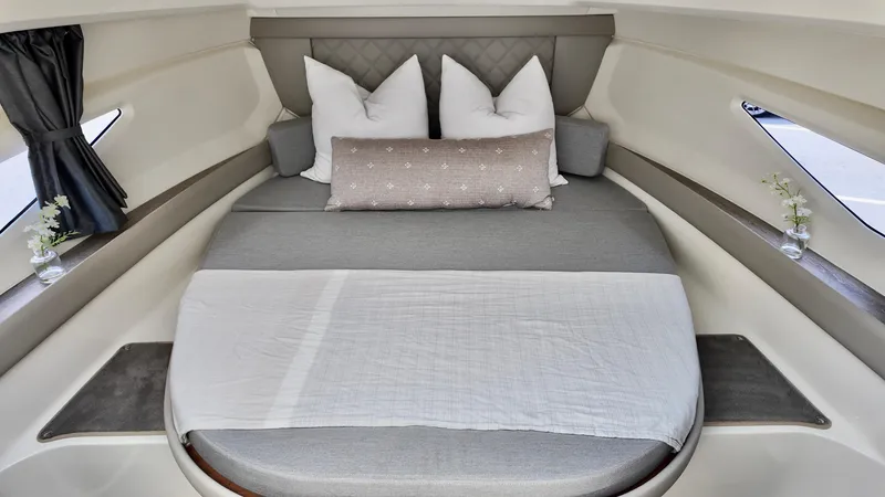 Slide: The Image of Luxurious cabin interior of 2026 Bayliner Trophy 29 Explorer with cozy bedding. - 27