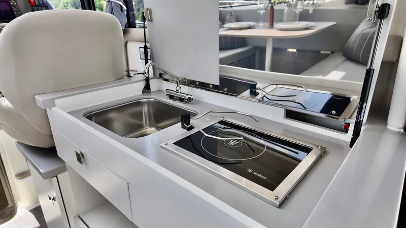 Slide: The Image of Modern kitchenette on 2026 Bayliner Trophy 29 Explorer boat with sink and stove. - 33