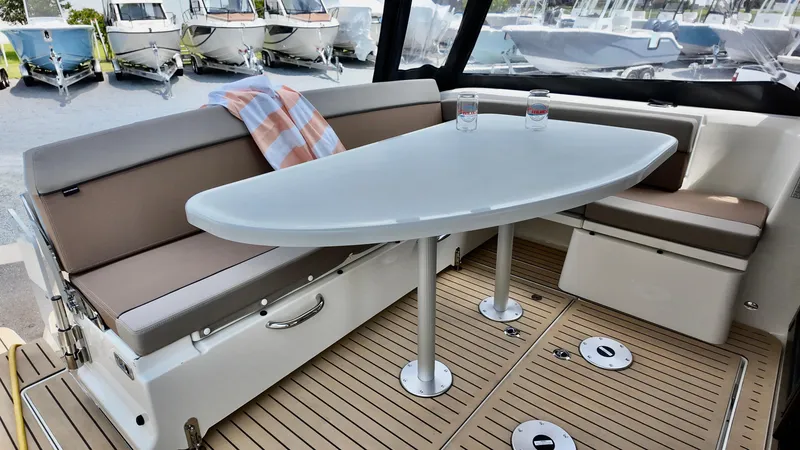 Slide: The Image of 2026 Bayliner Trophy 29 Explorer interior with seating and table, showcasing modern design. - 6