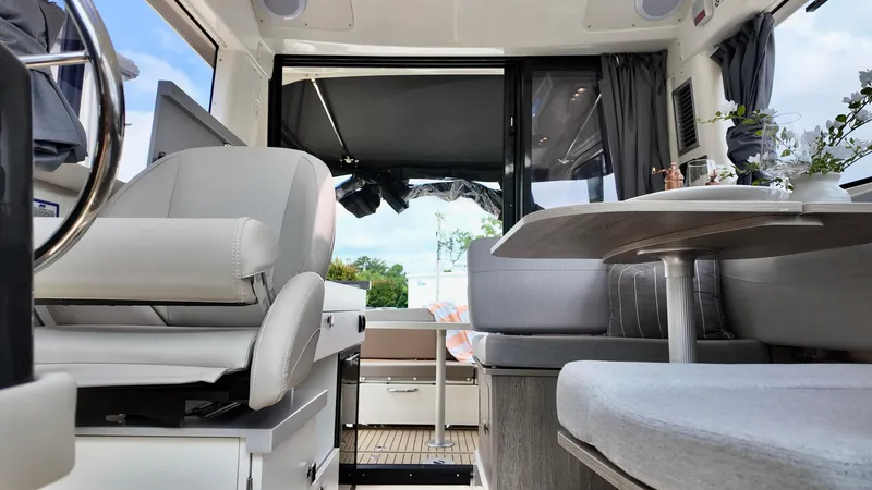 Slide: The Image of Interior of 2026 Bayliner Trophy 29 Explorer, featuring modern seating and dining area. - 7