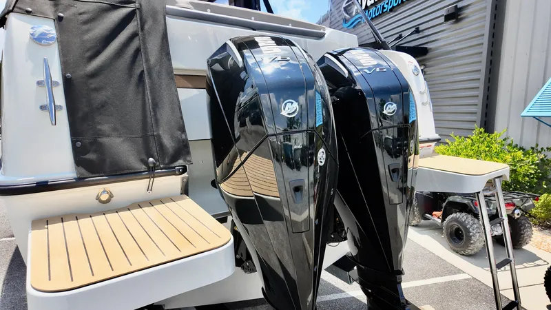 Slide: The Image of Bayliner Trophy 29 Explorer 2026 with dual Mercury outboard engines, docked outdoors. - 8