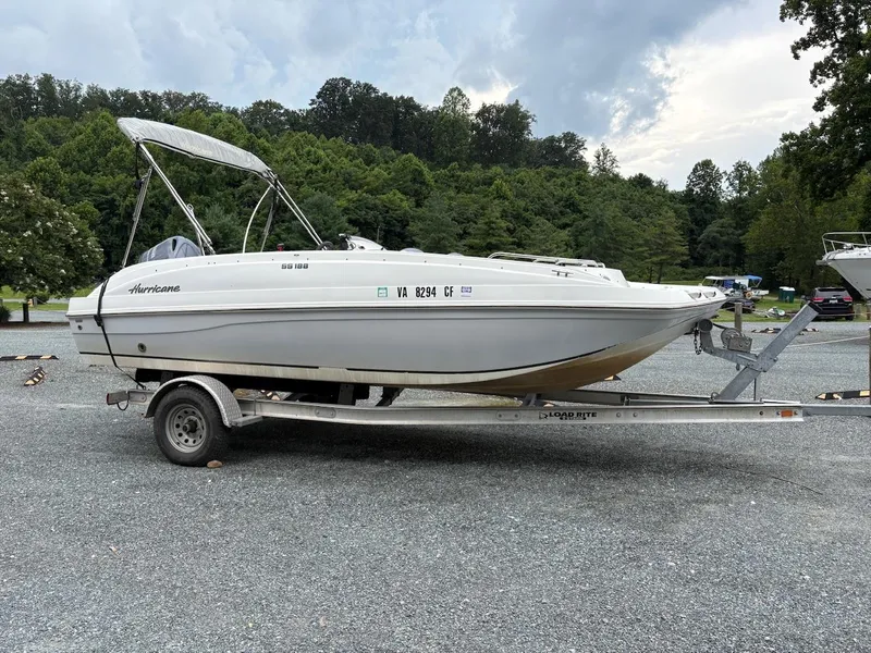 Slide: The Image of 2016 Hurricane 188 boat on trailer, parked in a scenic outdoor area. - 3