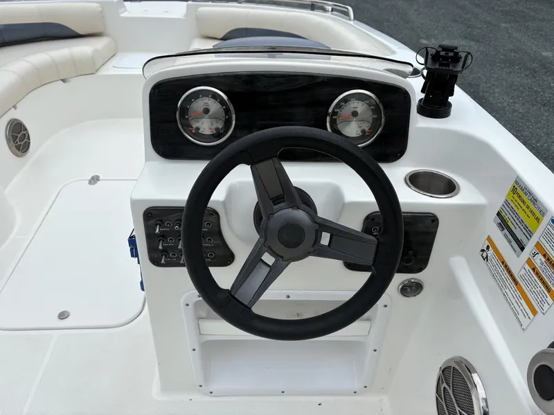Slide: The Image of Steering console of a 2016 Hurricane 188 boat with gauges and controls. - 4