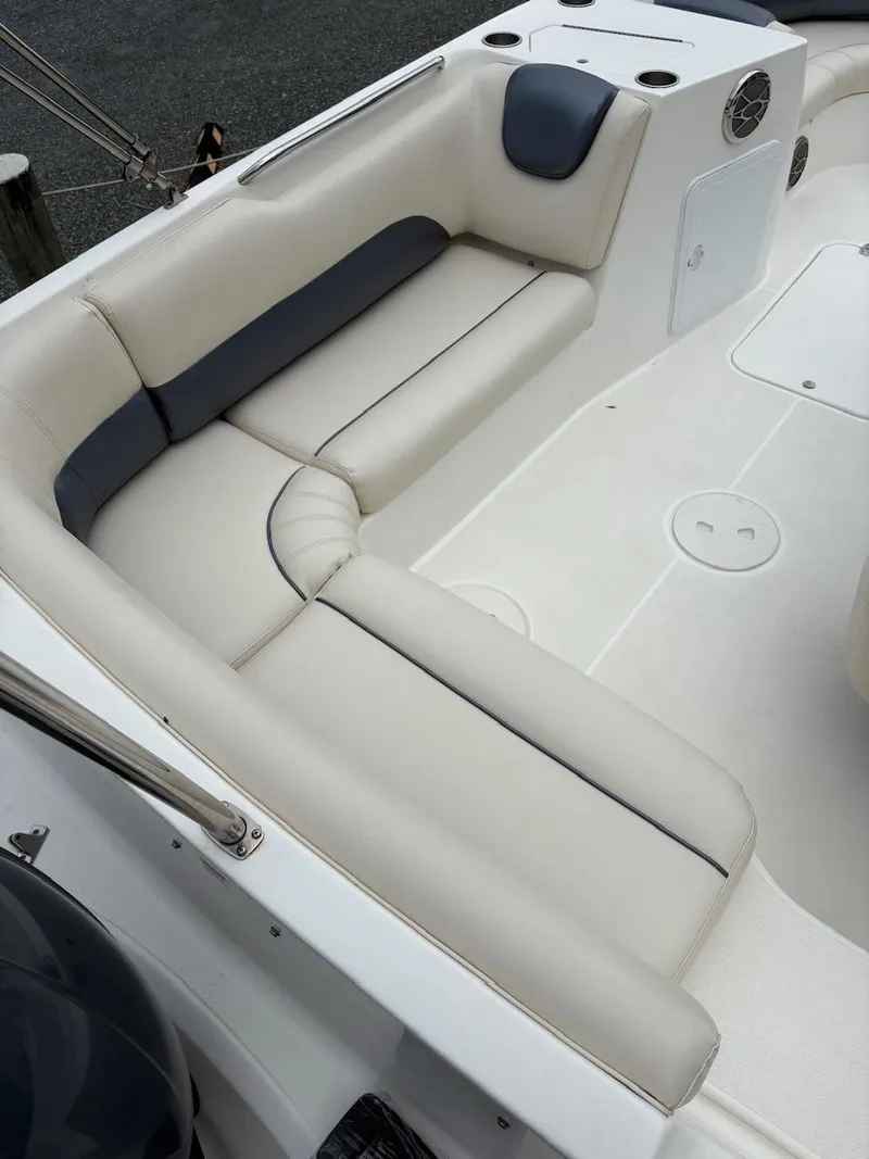 Slide: The Image of Interior seating of a 2016 Hurricane 188 boat, featuring white and gray upholstery. - 6
