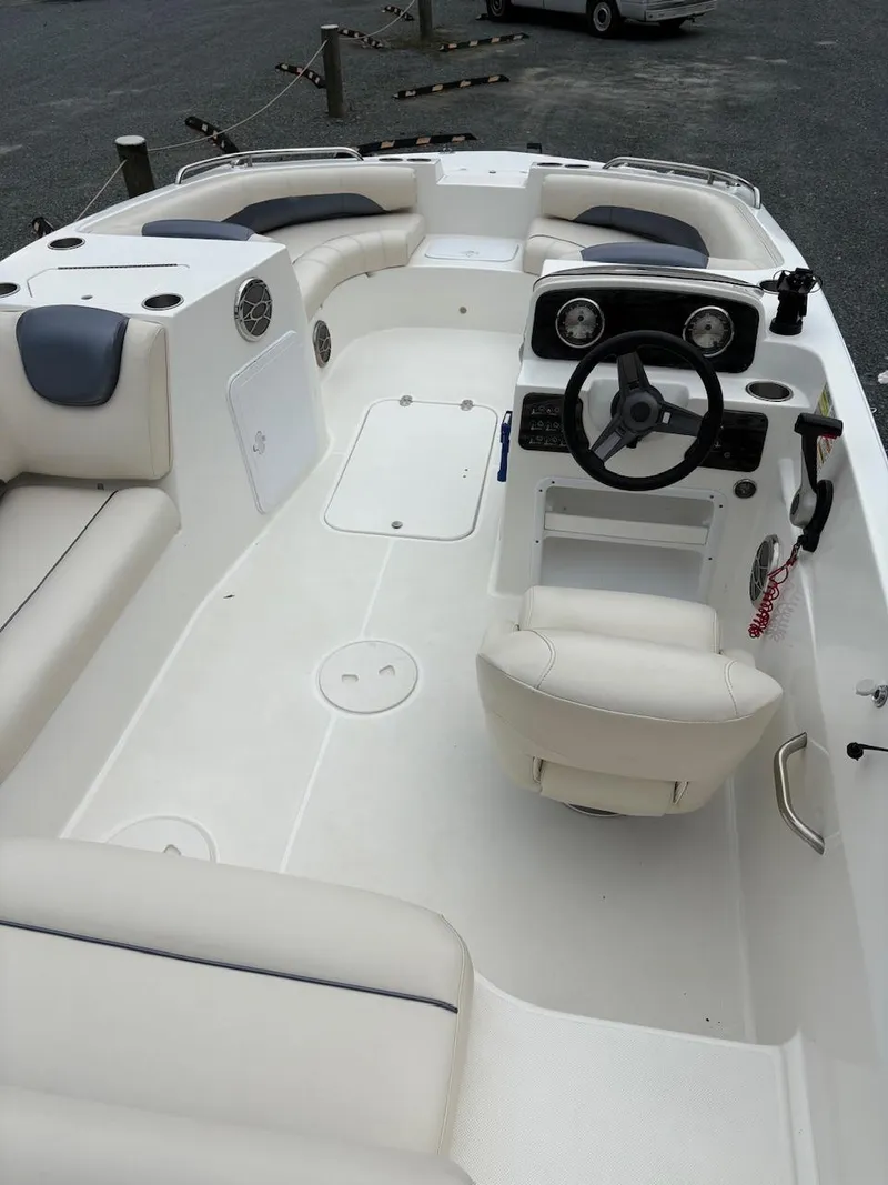 Slide: The Image of 2016 Hurricane 188 boat interior with steering wheel, seating, and control panel. - 7