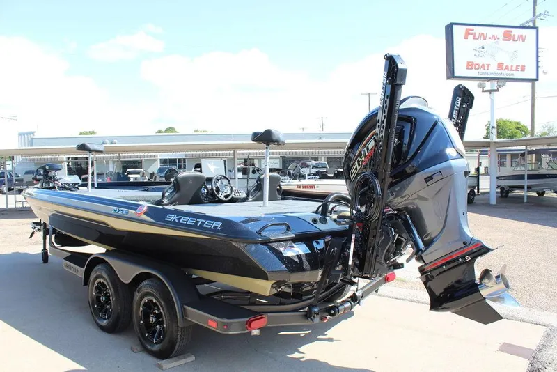 Slide: The Image of 2026 Skeeter ZXE21 boat at dealership, featuring powerful outboard motor and sleek design. - 10