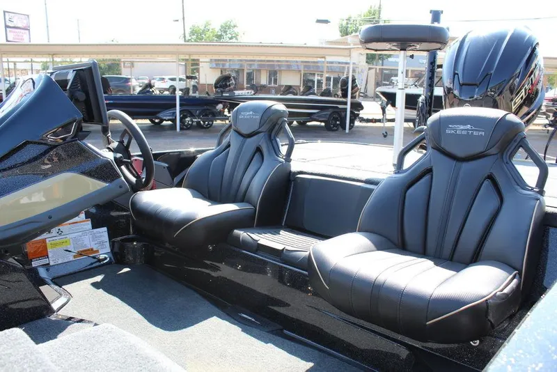 Slide: The Image of 2026 Skeeter ZXE21 boat interior with sleek black seats and modern dashboard. - 13