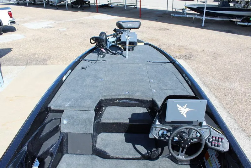 Slide: The Image of 2026 Skeeter ZXE21 boat interior with steering wheel and control panel. - 14