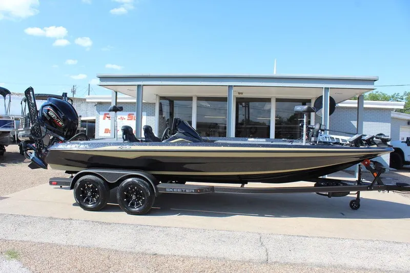 Slide: The Image of 2026 Skeeter ZXE21 boat on trailer, parked outside a dealership under a clear blue sky. - 3