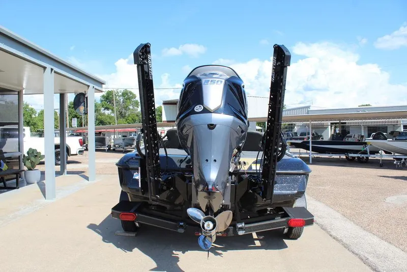 Slide: The Image of 2026 Skeeter ZXE21 boat with powerful outboard motor, parked outdoors. - 4