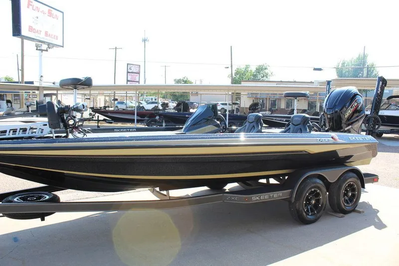 Slide: The Image of 2026 Skeeter ZXE21 boat on trailer at dealership, side view. - 6