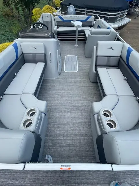 Slide: The Image of 2024 Bennington 22SXSWB pontoon boat interior with gray seating and cup holders. - 4