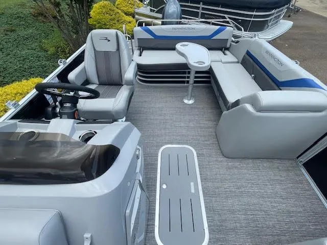 Slide: The Image of 2024 Bennington 22SXSWB pontoon boat interior with seating and steering console. - 5