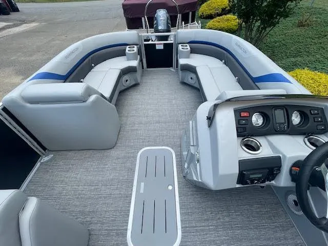 Slide: The Image of 2024 Bennington 22SXSWB pontoon boat interior with gray seating and modern dashboard. - 6